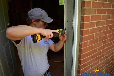 Drilling a hole for a strike plate in door trim